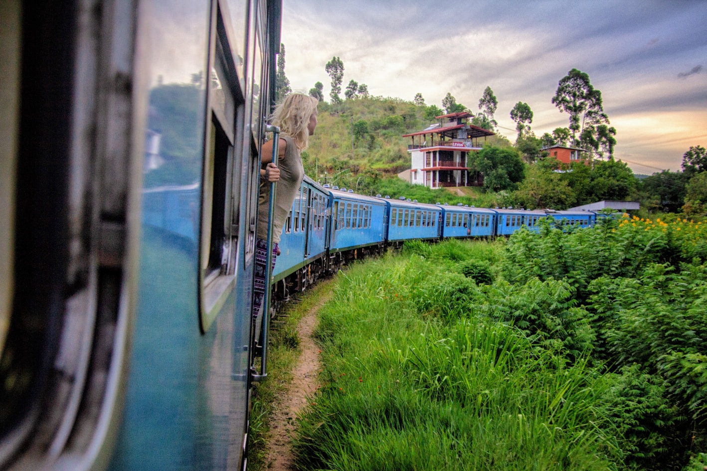 Train journey through lush green landscape